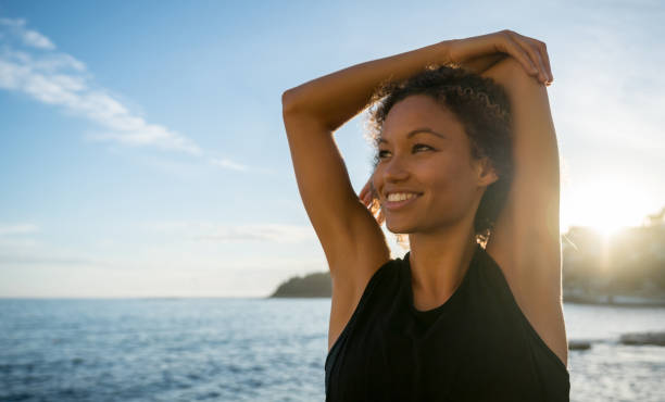 istock Happy woman exercising at the beach 940636504