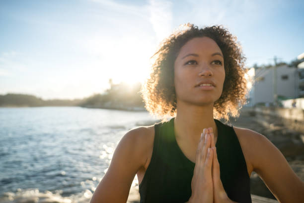 istock Woman doing yoga exercises at the beach 940636938