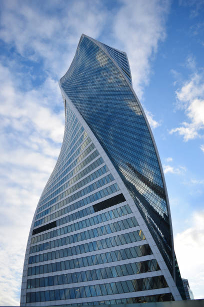 istock Low angle view of skyscrapers against cloudy sky 940639892