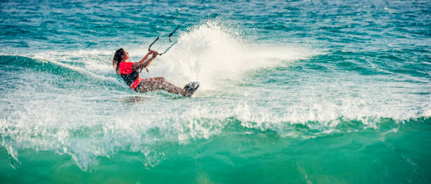 istock Female kiteboarder on turquoise water 940640026