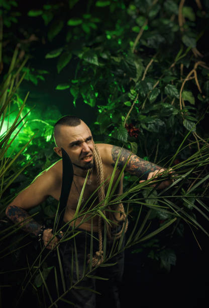 istock a man in the jungle with machetes attacking the enemy 940656900