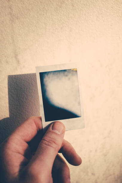 istock Holding an instant photo 940658170