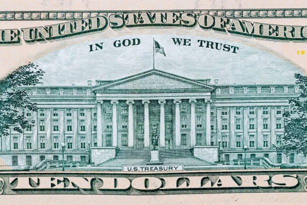 istock close-up 10 US dollar bills with in God we trust text and us treasury. Background 940670010