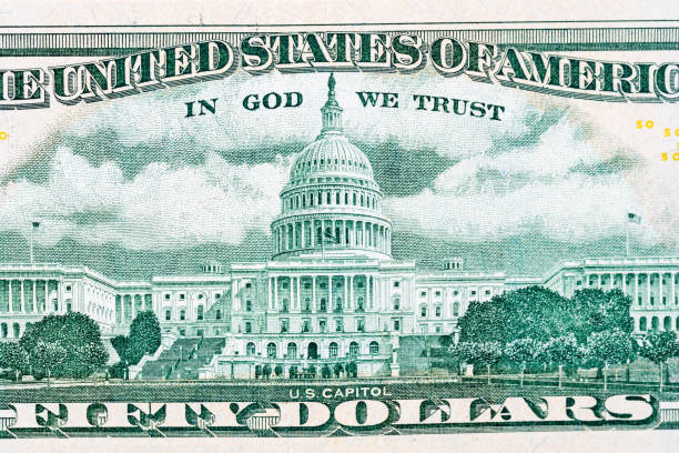 istock close-up 50 US dollar bills with in God we trust text. Background 940670324