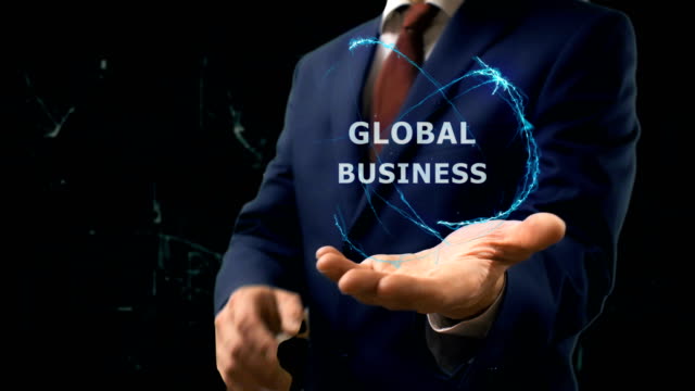 Businessman shows concept hologram Global Business on his hand