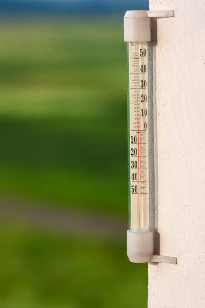 istock Thermometer celsius showing warm temperature on blurred green ba 940681008