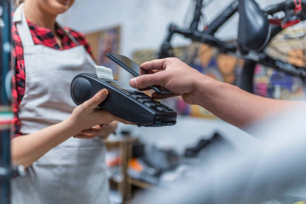 istock Serving a customer, bicycle shop, credit card payment 940689396