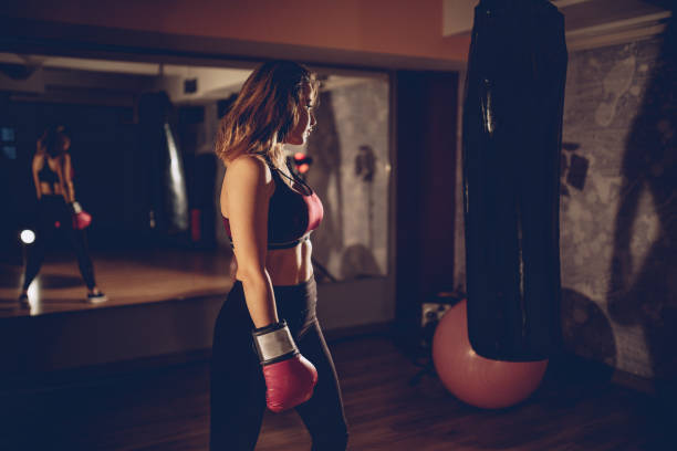 istock Pretty female boxer in the gym 940692990