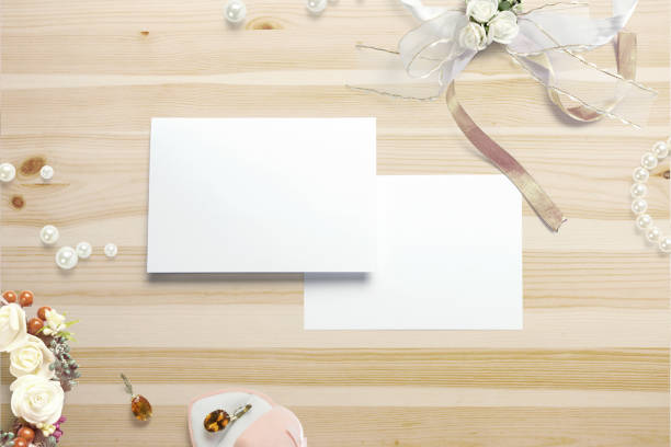 istock Blank event cards and decor on wooden table. 3d render. 940693056