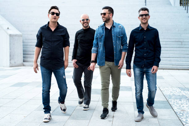istock Male Group with Sunglasses Walking on Pavement 940693352
