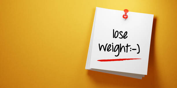 istock White Sticky Note With Lose Weight Message And Red Push Pin On Yellow Background 940700984
