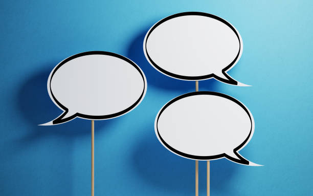 istock White Chat Bubbles With Wooden Sticks On Blue Background 940701920