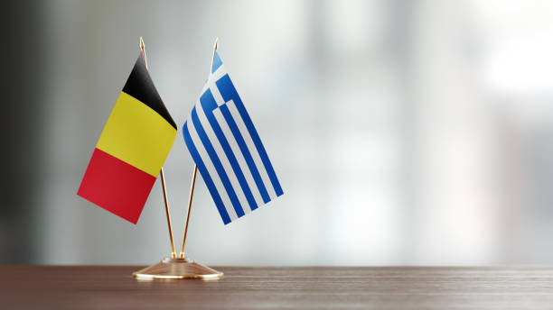 istock Belgian And Greek Flag Pair On A Desk Over Defocused Background 940706804