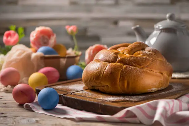 Photo of Easter folar with egg on wooden table top.