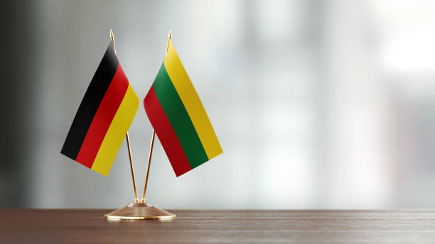 istock German And Lithuanian Flag Pair On A Desk Over Defocused Background 940709662