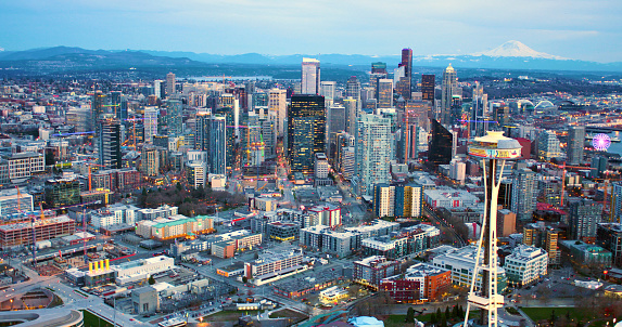Seattle Washington USA - March 12 2018 Seattle Space Needle Under Remodeling Construction with Seattle Skyline and Mt Rainer Background Aerial Panorama Shot From Helicopter