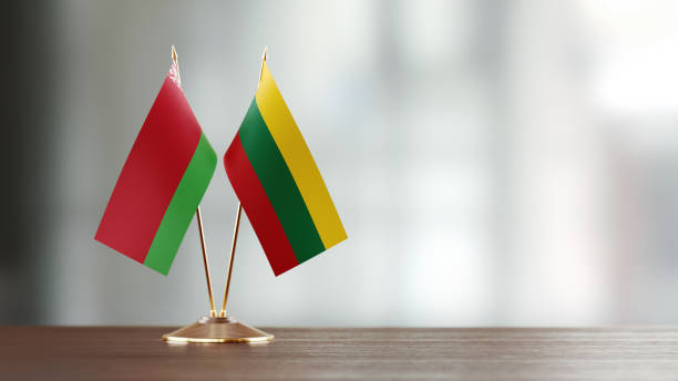 istock Belarus And Lithuanian Flag Pair On A Desk Over Defocused Background 940709828