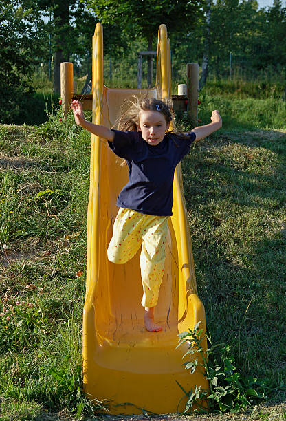 走るのスライド - playground schoolyard playful playing ストックフォトと画像