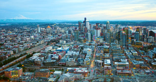 istock Seattle Washington Infrastructure Helicopter Aerial Angle Above City Downtown Core Facing Huge Mount Rainier Large Cascade Mountain Pacific Northwest 940712250
