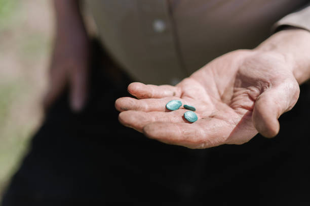 istock Pumpkin seeds on the palm of a man 940712416