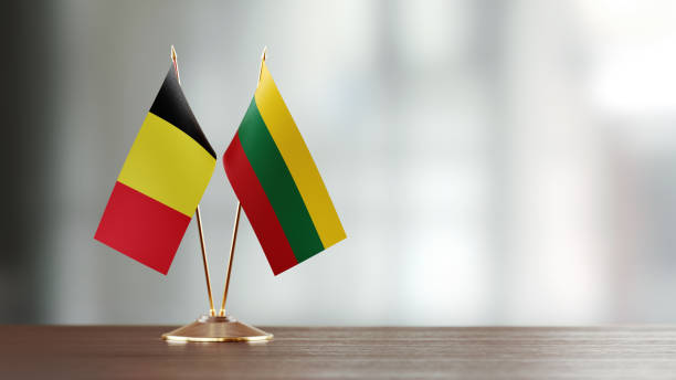 istock Belgian And Lithuanian Flag Pair On A Desk Over Defocused Background 940712912