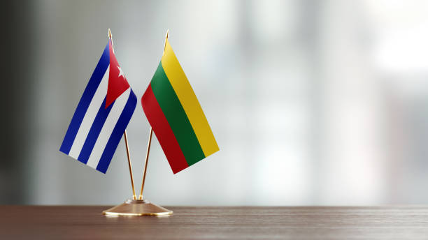 istock Cuban And Lithuanian Flag Pair On A Desk Over Defocused Background 940713164
