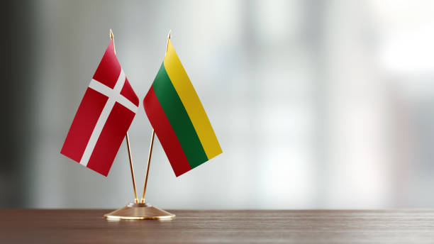 istock Danish And Lithuanian Flag Pair On A Desk Over Defocused Background 940713288