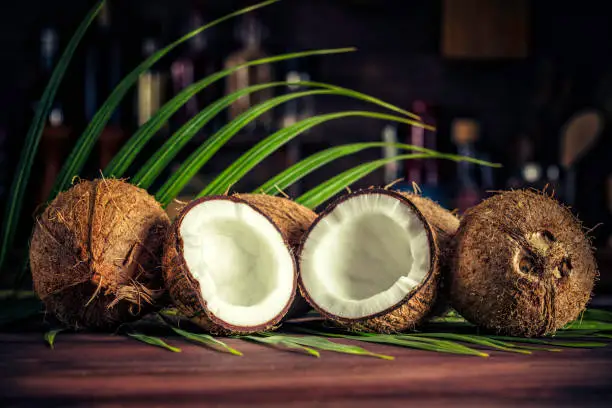 Photo of Low key of coconuts on wooden rustic table