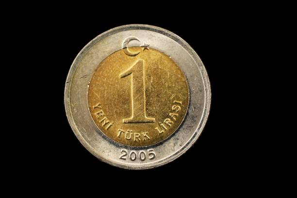 istock Turkish One Lira bimetallic Coin Isolated On Black 940715956