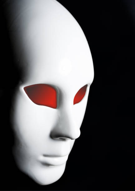 istock White mask of man's face on black background 940716170