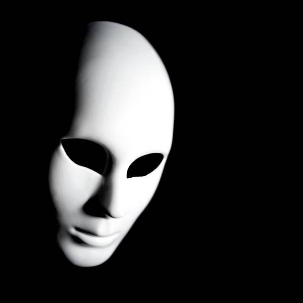 White masks playing dress up for the masquerade ball with a black cloth