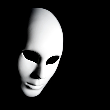 White mask of man's face on black background