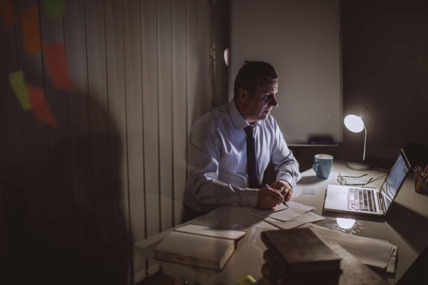 istock Mature businessman working late 940716238