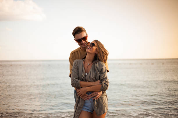 istock Millennial couple enjoying spring picnic by the beach 940719722