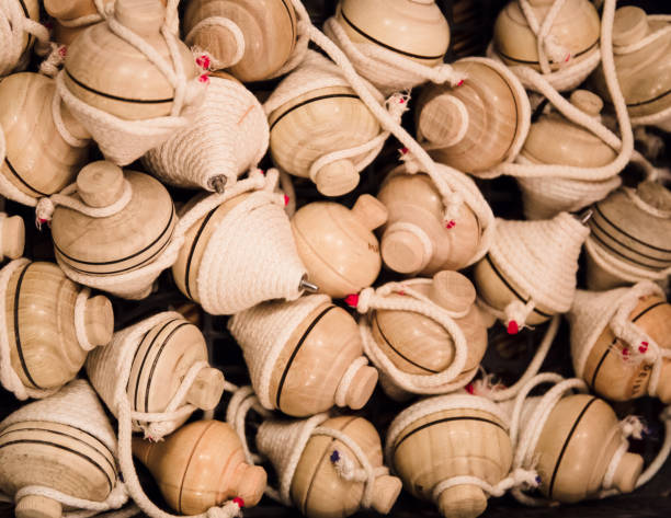 istock Vintage wooden spinning top toys with string. 940720166