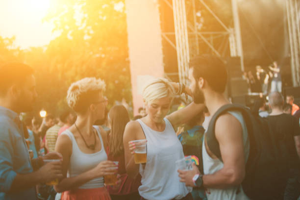 istock Four people dancing and drinking beer on festival 940723058