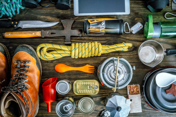 Top view of travel equipment and accessories for mountain hiking trip on wood floor Top view of travel equipment and accessories for mountain hiking trip on wood floor. survival tools stock pictures, royalty-free photos & images