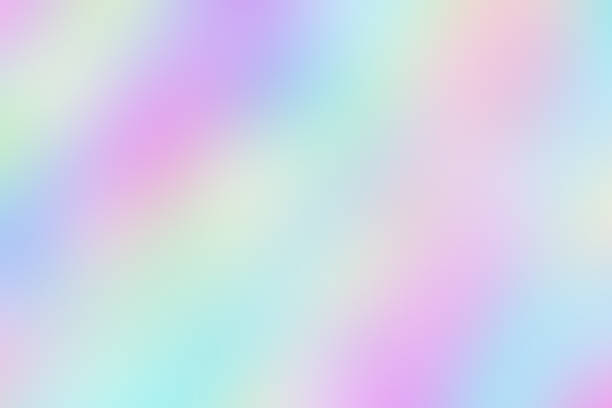 Blurred unclear iridescent background of smooth holographic paper. Blurred unclear iridescent diagonal background of smooth holographic paper. foil material stock pictures, royalty-free photos & images