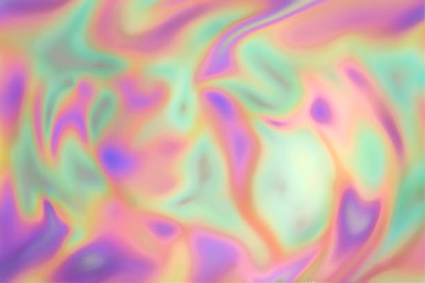 istock Defocused iridescent background of slightly twisted smooth holographic paper. 940741236