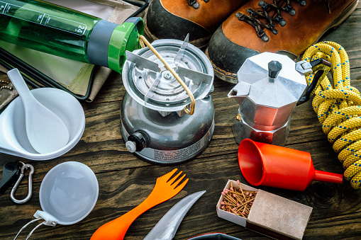 Cooking set . Travel equipment and accessories for mountain hiking trip on wood floor