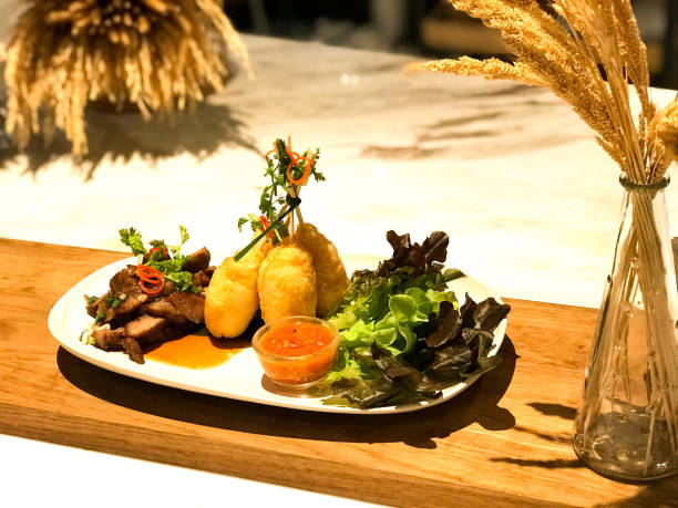 istock Roasted Pork & Gilled Sticky Rice with egg “Khao Jee” in modern style 940750916