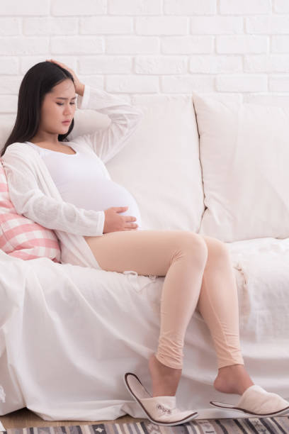 istock pregnant woman touch her belly 940751138