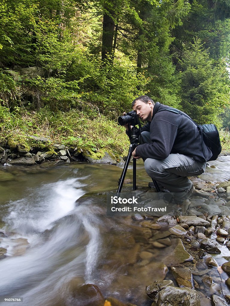 Photographer with camera on tripod  Camera - Photographic Equipment Stock Photo