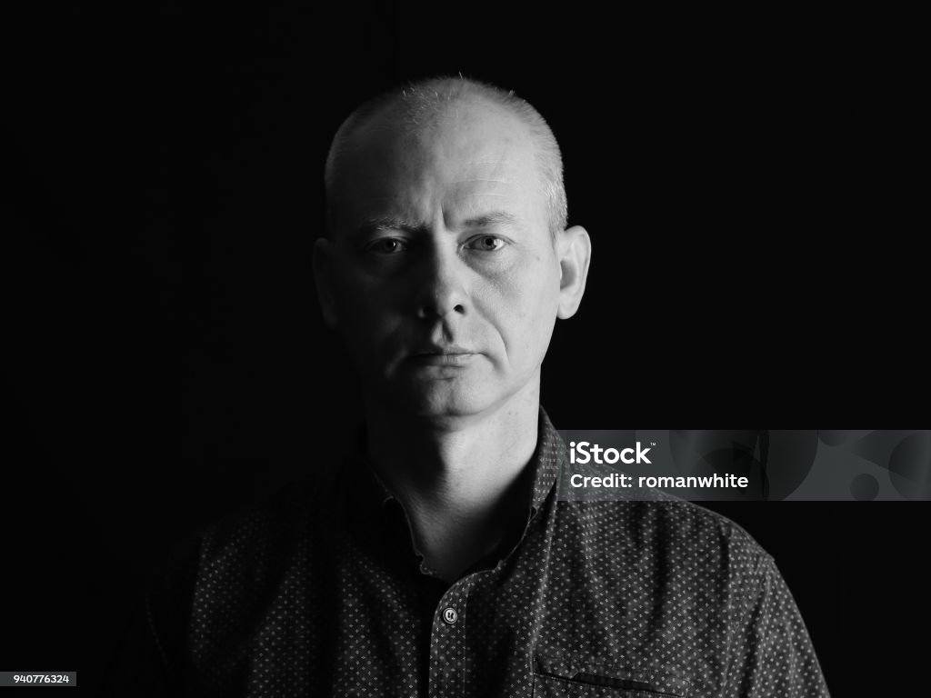 Close-up face of serious man on dark background. Portrait Stock Photo