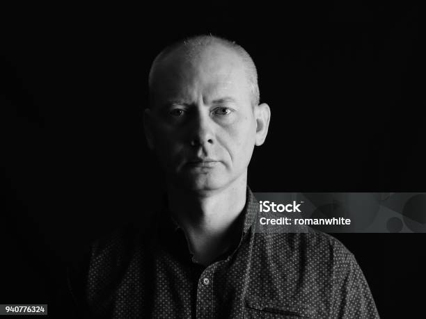 Closeup Face Of Serious Man On Dark Background Stock Photo - Download Image Now - Portrait, Black And White, Human Face