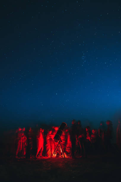 Astronomers looking at stars in a telescope