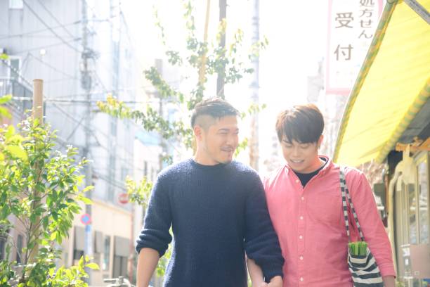 istock Young same sex couple outdoors shopping together 940788912