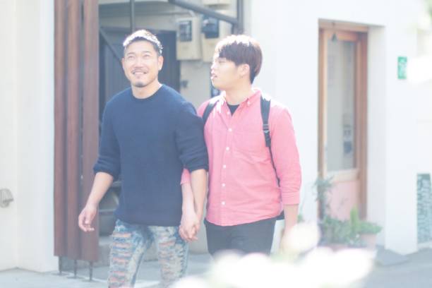 istock Young same sex couple walking together 940788986