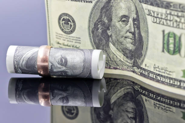 istock fifty dollar bill is rolled into elegant women's gold ring 940791508