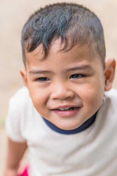 istock Face close up of boy mix race smiling 940799112